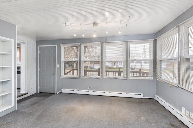 unfurnished sunroom with a baseboard heating unit