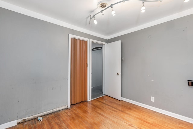 unfurnished bedroom featuring light hardwood / wood-style flooring and ornamental molding