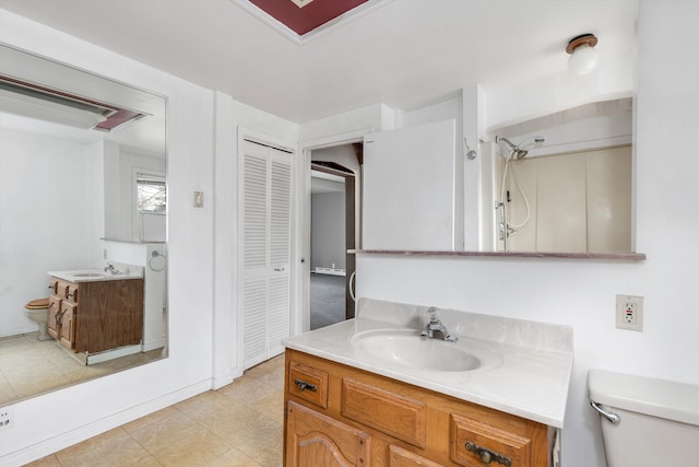 bathroom featuring vanity, walk in shower, and toilet