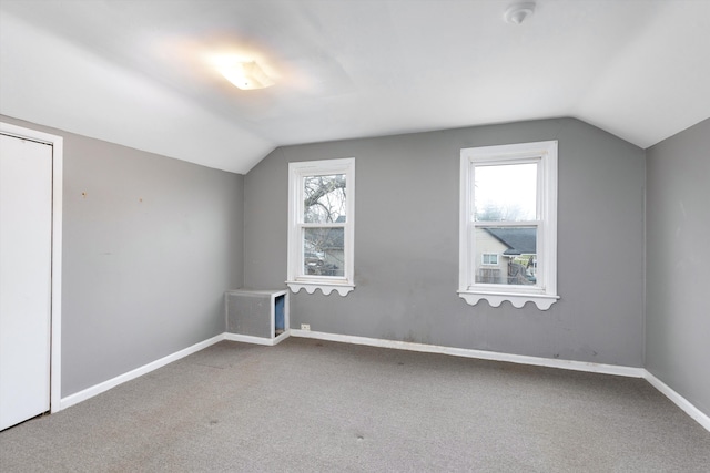 bonus room featuring lofted ceiling and carpet flooring