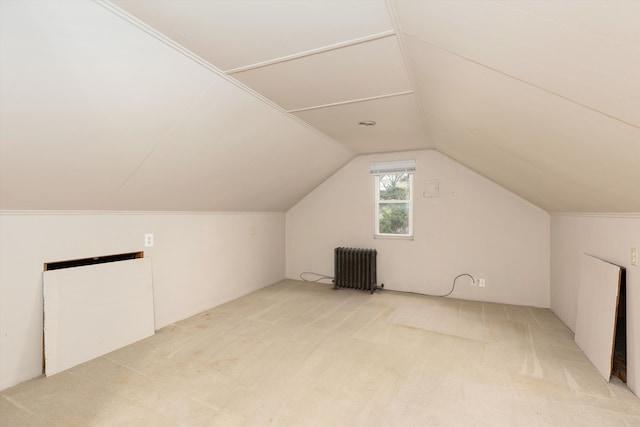 additional living space featuring lofted ceiling, radiator heating unit, and carpet flooring