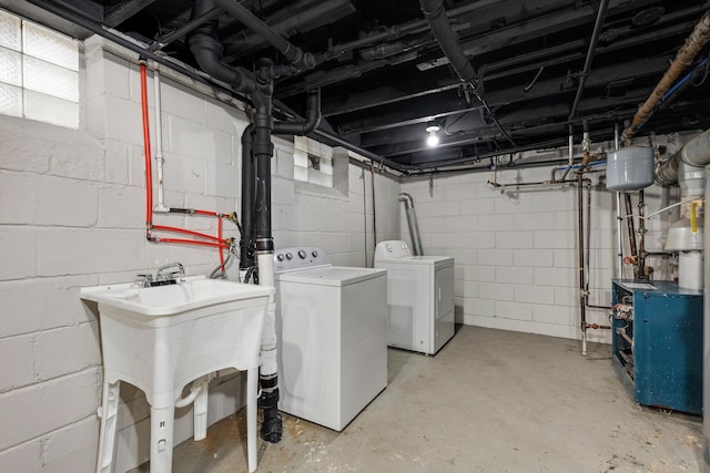 laundry area with separate washer and dryer and sink