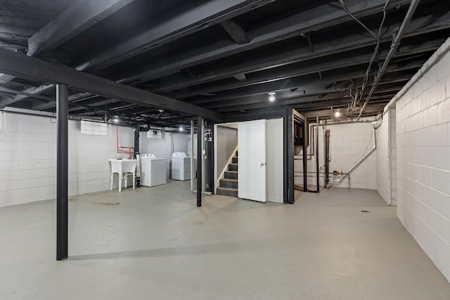 basement with washing machine and dryer and sink