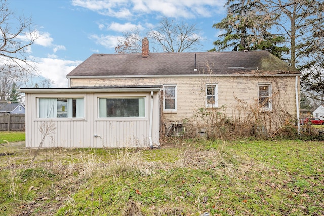 back of property featuring a lawn