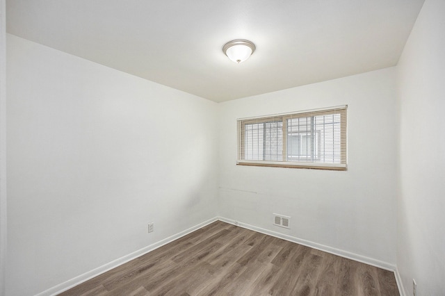 spare room with hardwood / wood-style floors