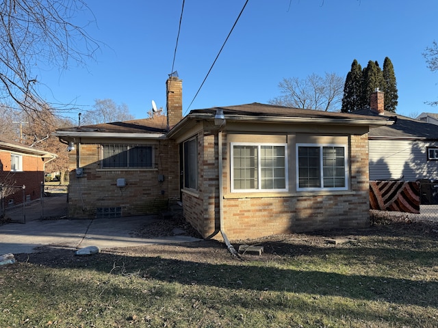 back of property featuring a lawn and a patio area