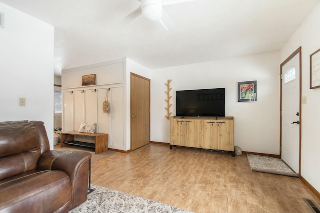 living room featuring ceiling fan and light hardwood / wood-style floors