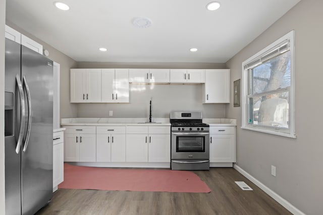 kitchen with sink, white cabinetry, and stainless steel appliances