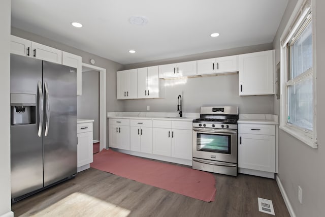 kitchen with sink, white cabinetry, and stainless steel appliances