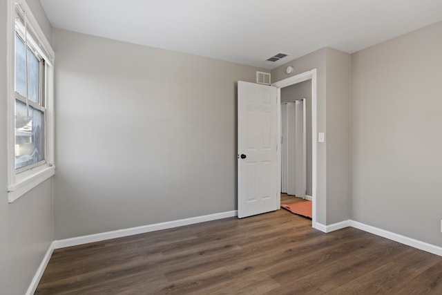 spare room featuring dark hardwood / wood-style floors