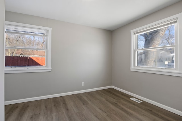 unfurnished room featuring dark hardwood / wood-style flooring