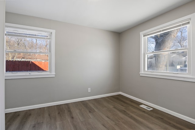 spare room featuring dark hardwood / wood-style floors