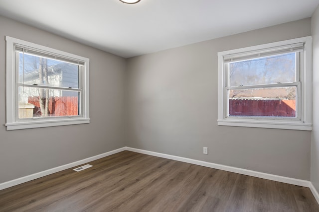 empty room featuring dark wood-type flooring