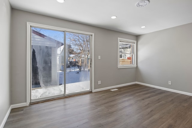 empty room with hardwood / wood-style flooring