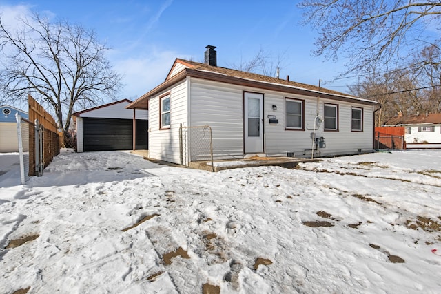 snow covered house with a carport