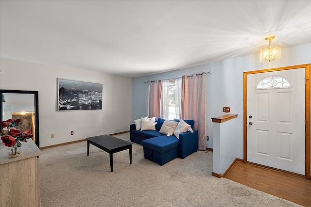 carpeted living room with a notable chandelier