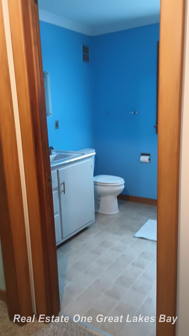 bathroom with toilet and vanity