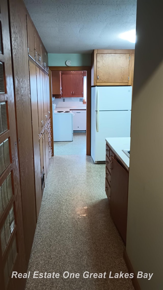 kitchen with white appliances and a textured ceiling