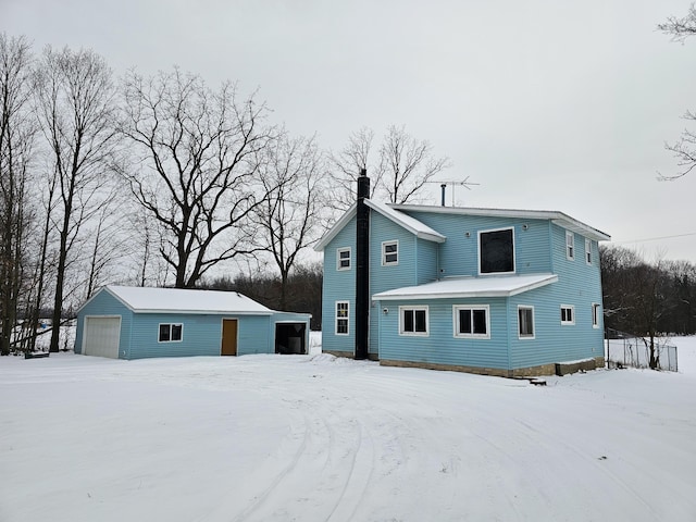 view of front of house with a garage and an outdoor structure