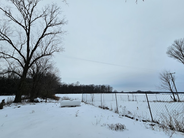 yard covered in snow with fence