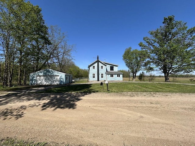950 Herl Rd, Bronson, MI 49028 - view of front of house with a detached garage, an outbuilding, driveway, and a front lawn
