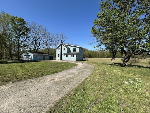 950 Herl Rd, Bronson, MI 49028 - view of front facade with a front lawn, asphalt driveway, and a garage