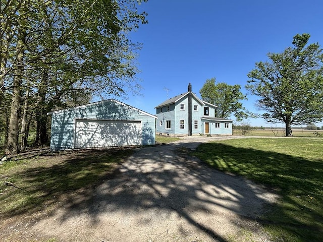 950 Herl Rd, Bronson, MI 49028 - view of front of house featuring an outbuilding, a garage, and a front yard