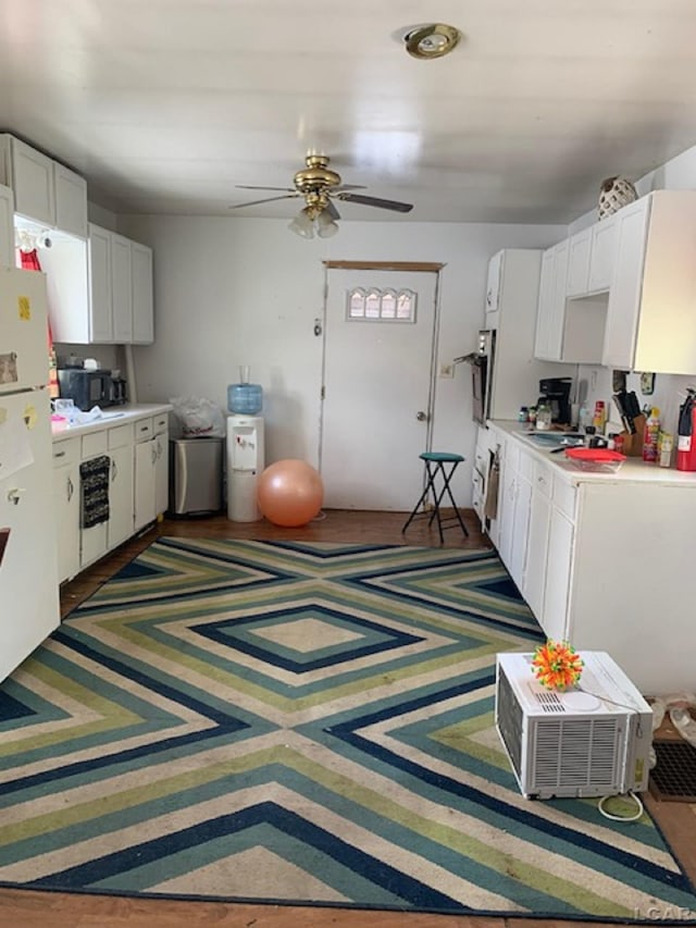 kitchen featuring ceiling fan, white cabinetry, and white refrigerator