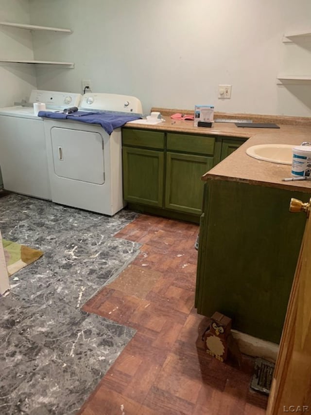 laundry room with washer and dryer and cabinets