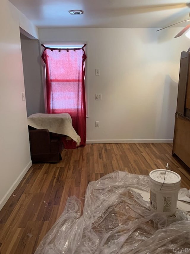 unfurnished bedroom featuring ceiling fan and dark hardwood / wood-style flooring