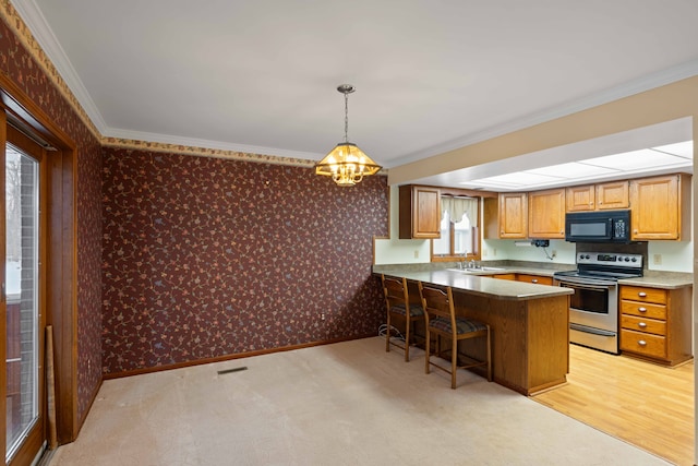 kitchen with pendant lighting, a kitchen bar, stainless steel range with electric stovetop, ornamental molding, and kitchen peninsula