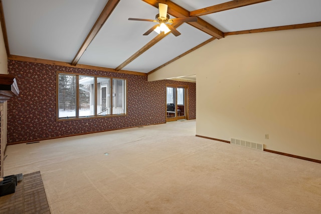 unfurnished living room featuring vaulted ceiling with beams, light colored carpet, a brick fireplace, and ceiling fan