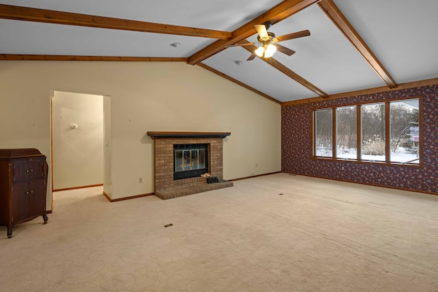 unfurnished living room with ceiling fan, a fireplace, light carpet, and vaulted ceiling with beams