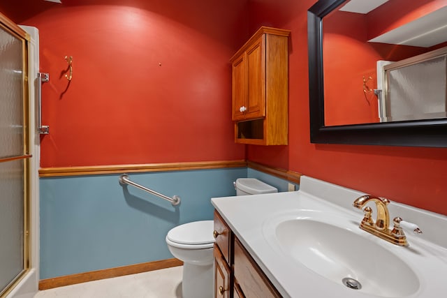 bathroom featuring vanity, tile patterned flooring, toilet, and walk in shower