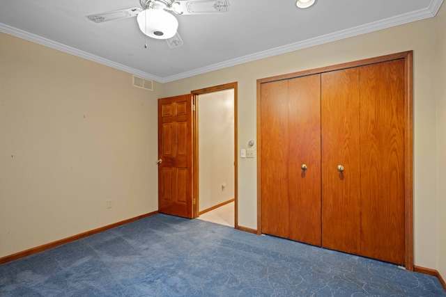 unfurnished bedroom featuring crown molding, ceiling fan, carpet, and a closet