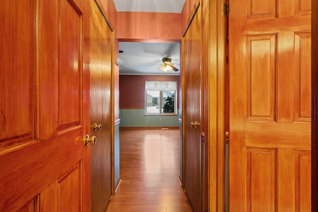 hall featuring crown molding and light wood-type flooring