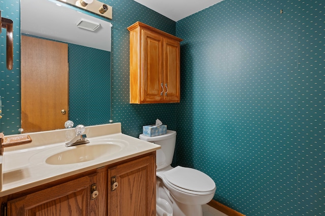 bathroom with vanity and toilet