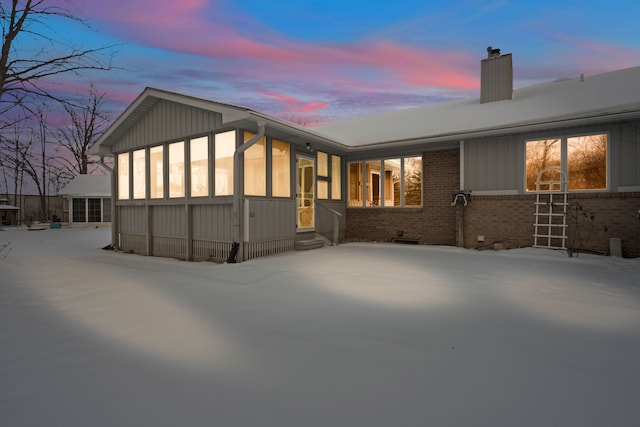 view of back house at dusk