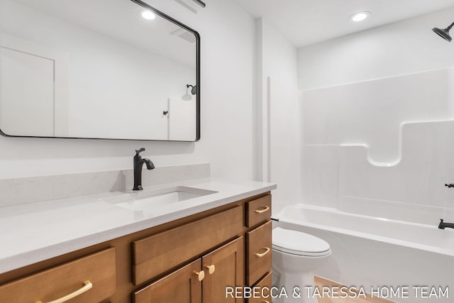 full bathroom featuring vanity, bathing tub / shower combination, and toilet