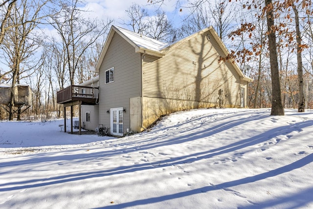 snow covered property featuring a deck