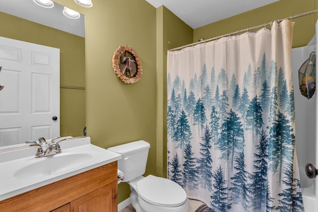 bathroom with toilet, vanity, and a shower with shower curtain