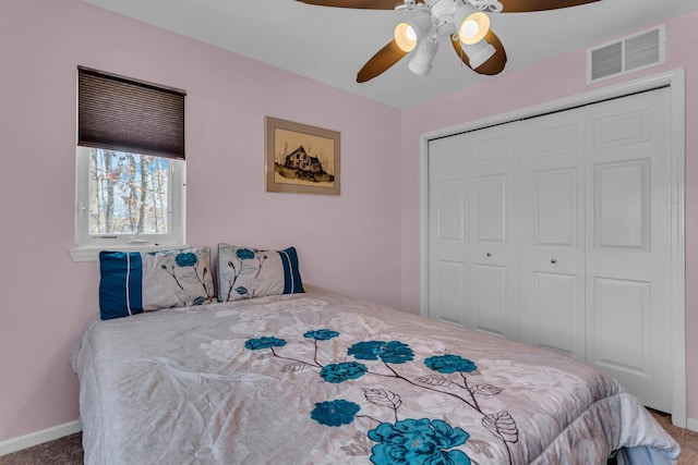 bedroom with ceiling fan, a closet, and carpet flooring