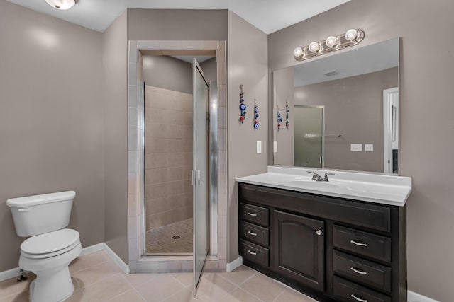 bathroom with toilet, a shower with door, vanity, and tile patterned flooring