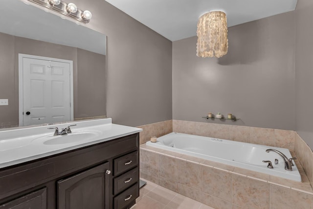 bathroom featuring a relaxing tiled tub, tile patterned floors, and vanity