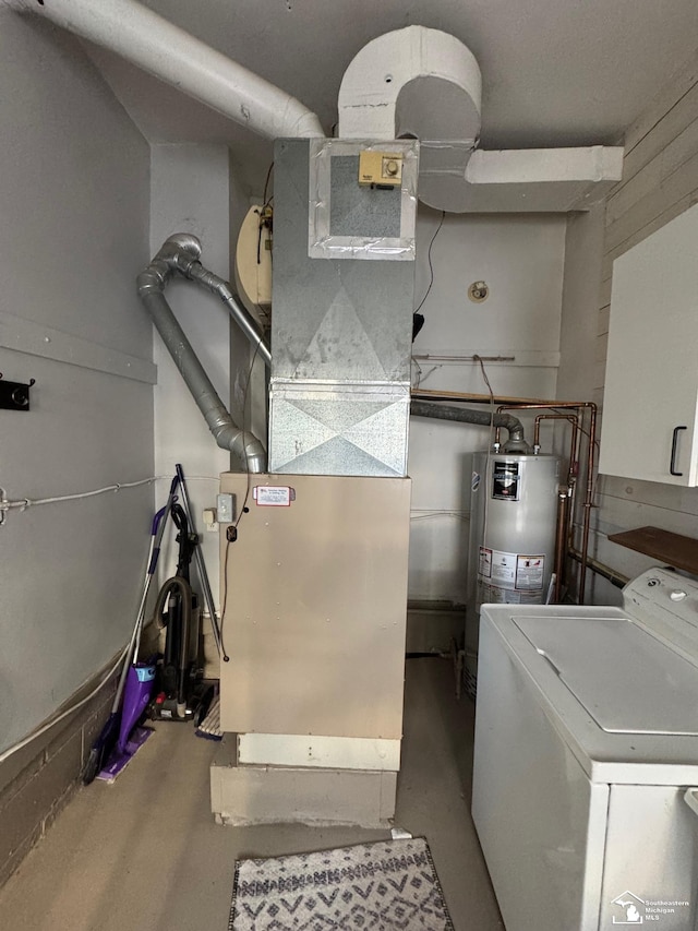 utility room featuring water heater and washer / clothes dryer