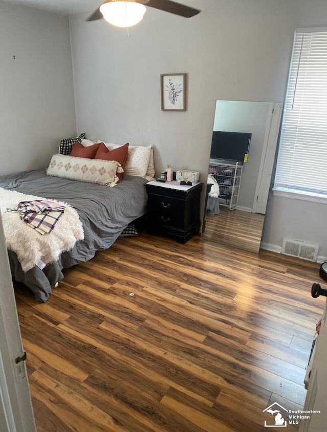 bedroom featuring ceiling fan and dark hardwood / wood-style flooring