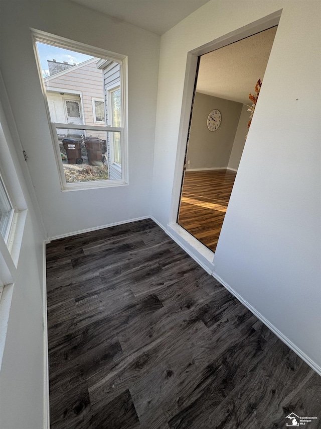 empty room featuring dark hardwood / wood-style flooring