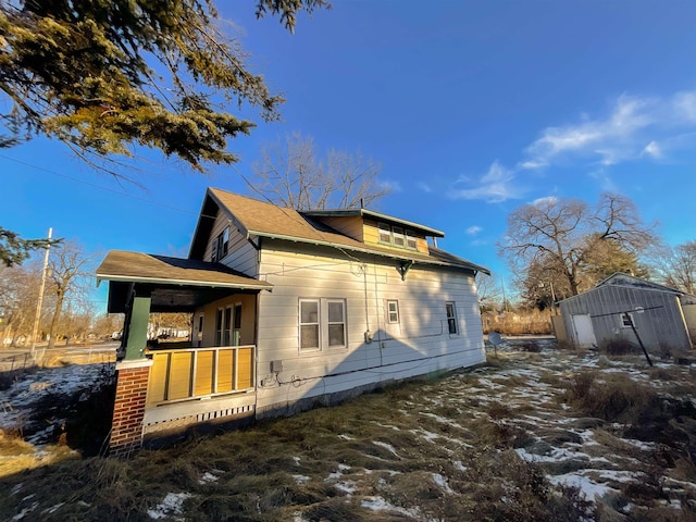 view of snow covered exterior featuring a porch