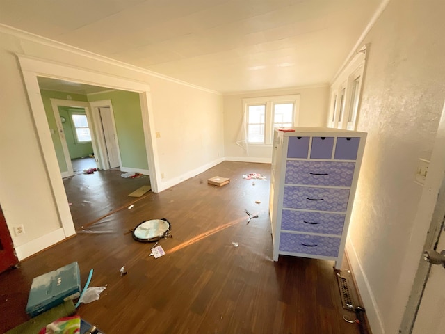 interior space with dark wood-type flooring and ornamental molding