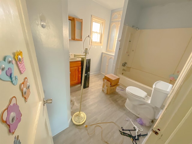 full bathroom featuring toilet, vanity, and bathing tub / shower combination